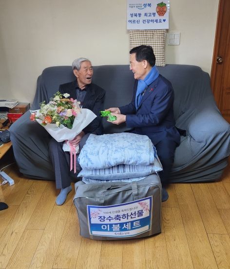이승로 성북구청장이 3일 어르신댁을 방문하여 어르신이 선택한 장수축하물품인 이불세트를 전달하고 있다.